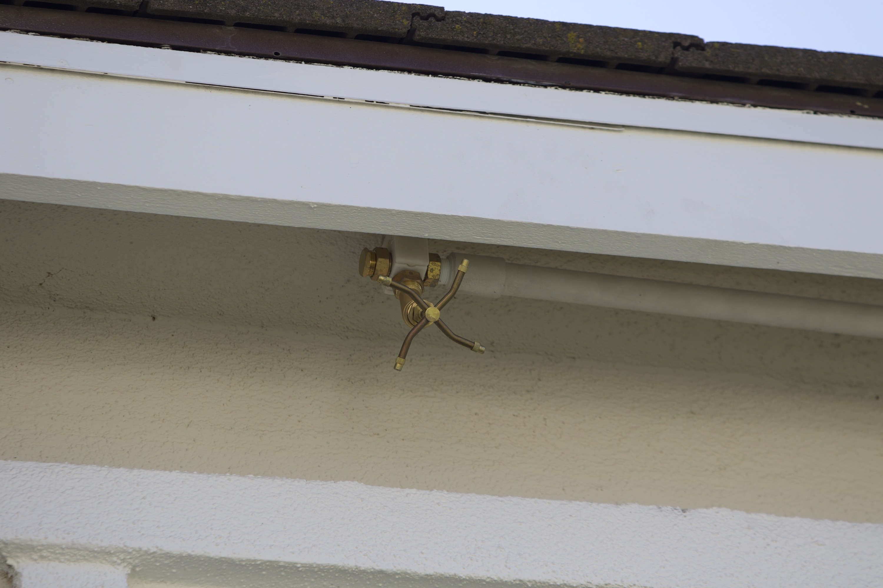 Eave sprinklers creating a defensive water curtain along the perimeter