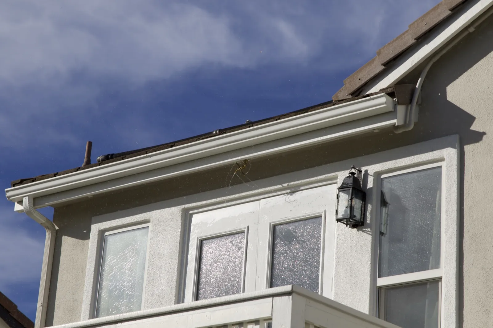 Eave sprinklers spraying along the edge of a roof